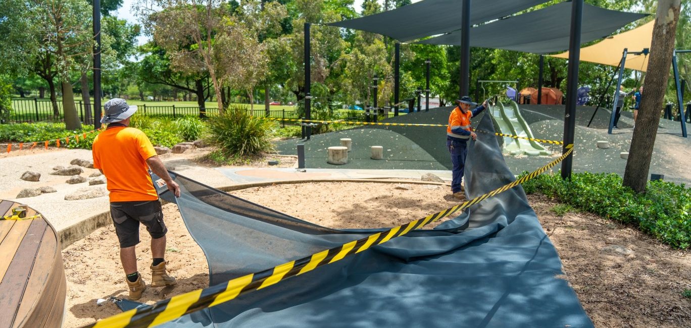 Council staff removing shade sails at the Jezzine Barracks Precinct ahead of wet weather forecast for the weekend.