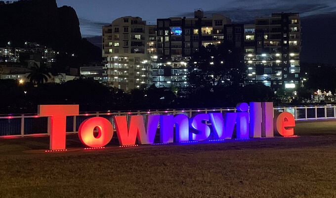 Townsville sign lit up in red and blue