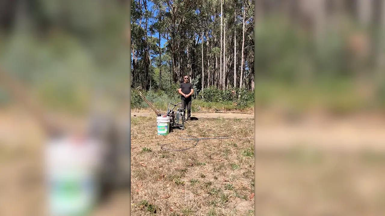 Anthony Sawrey standing with his art tools
