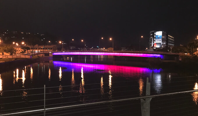 Victoria Bridge lit in blue, purple and red