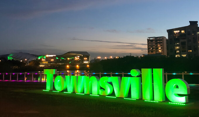 Townsville sign lit up in green