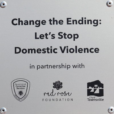 Red Bench Plaque that says Change the Ending Let's Stop Domestic Violence