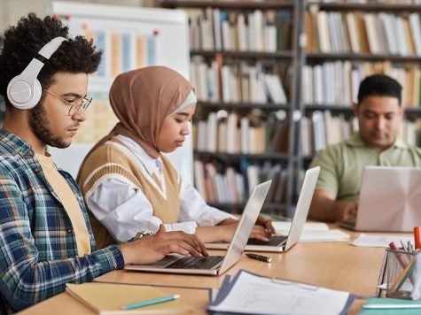 Visitors studying on laptops at the library