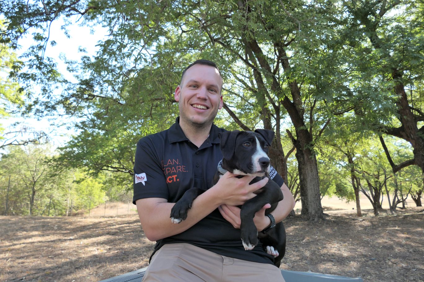 Cr Brodie Phillips with puppy Brisket, who is available for adoption at the Animal Care and Adoption Centre