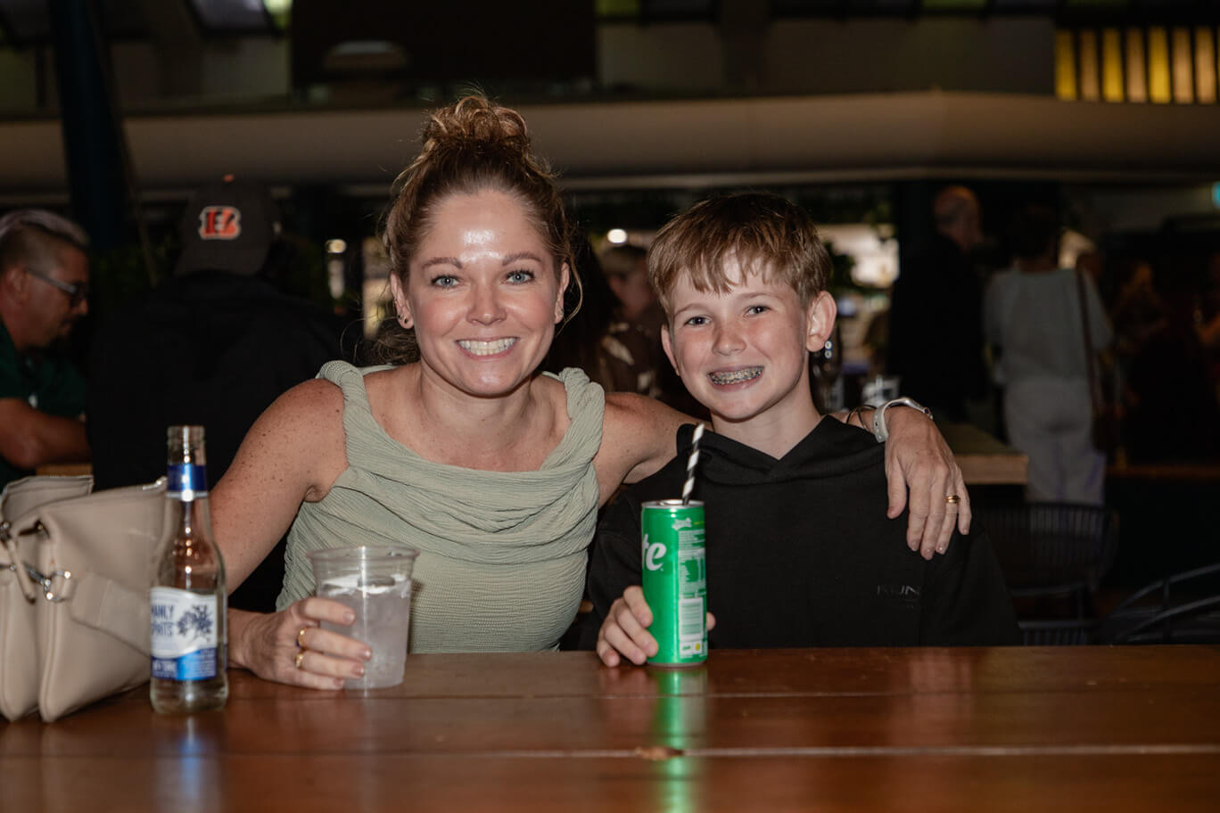 Mother and child posing at table outside Townsville Civic Theatre