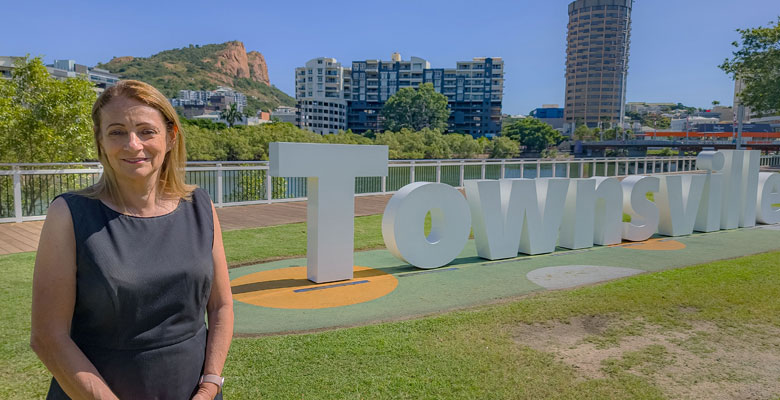 Caption: Mayor Jenny Hill at the Townsville sign at Central Park. Mayor Jenny Hill at the Townsville sign at Central Park