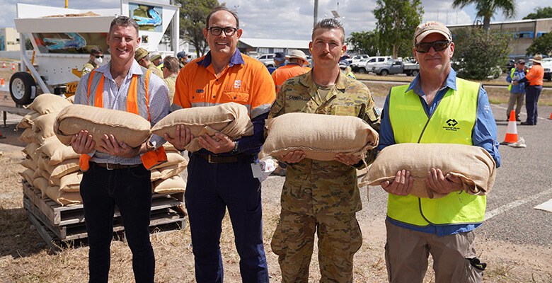 David Fanning, Matt Richardson, Lucas Carroll and Robert Buzzard holding sandbags