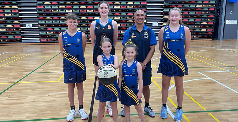 Townsville Fire Guard Saffron Shiels and Cowboys Program Manager Ray Thompson with junior netballers