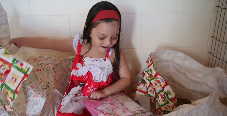 Five year old Maya Martinez Flores is ready to recycle wrapping paper from her gifts this weekend