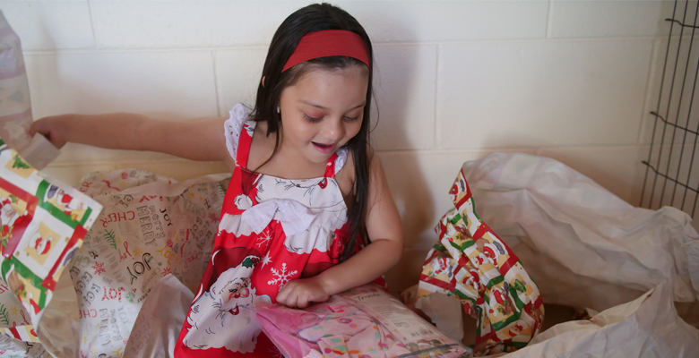 Caption: Five year old Maya Martinez Flores is ready to recycle wrapping paper from her gifts this weekend. Five year old Maya Martinez Flores is ready to recycle wrapping paper from her gifts this weekend