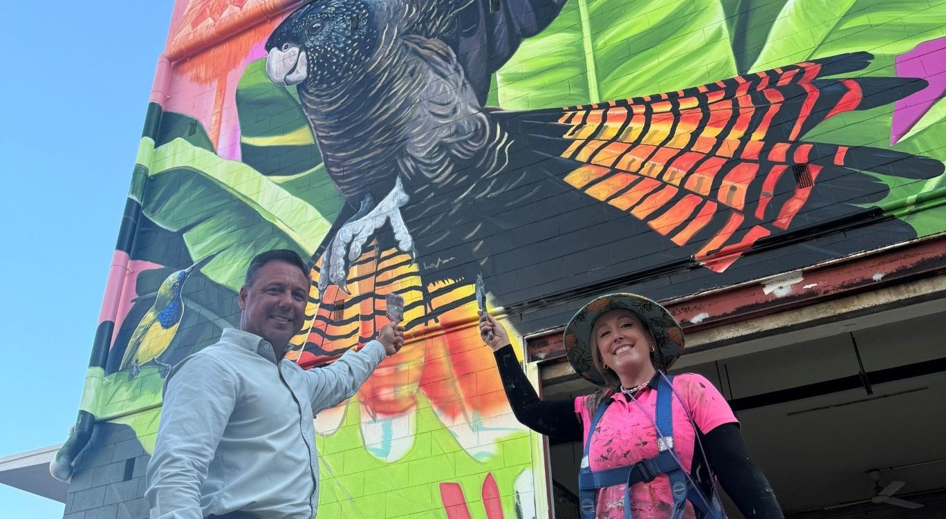 Artist Art by Lavinia and Townsville Mayor Nick Dametto in front of the new Tropical State of Mind mural at 408-410 Flinders Street.