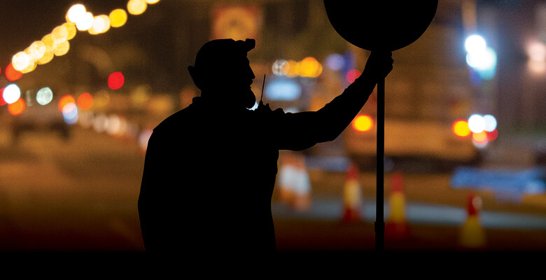 A Council worker's silhouette a night.