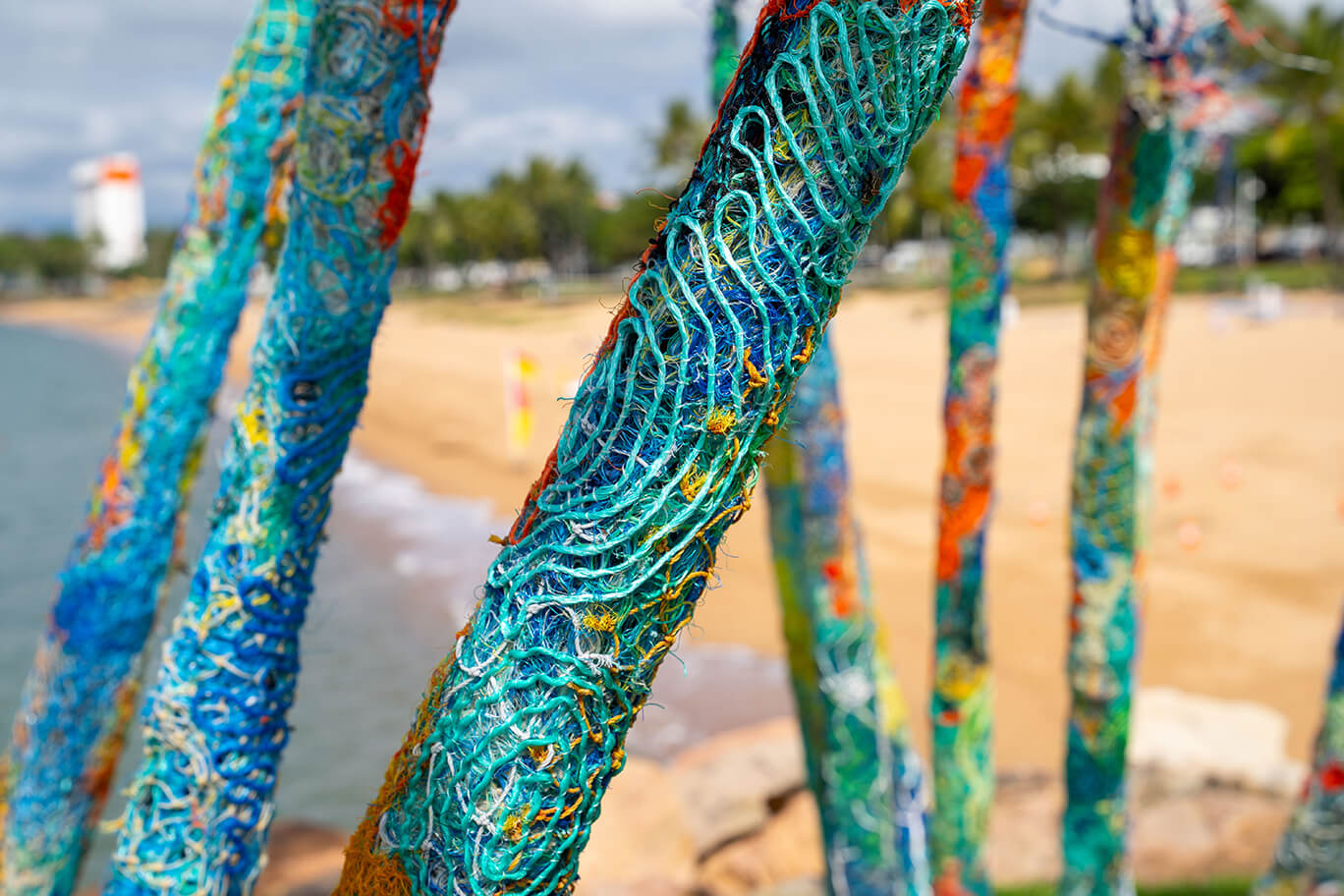 Anemones made of ghost net, beach found rope, sand, fabric, and fishing rod supports