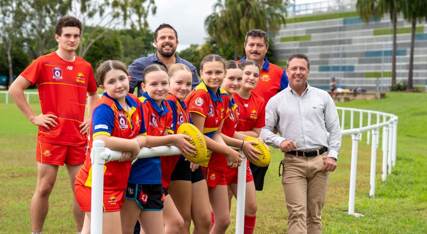 Member for Hinchinbrook Wayde Chiesa, Northern Beaches Suns AFL Club president Mark Boardman and Townsville Mayor Nick Dametto with club players at The Green. 