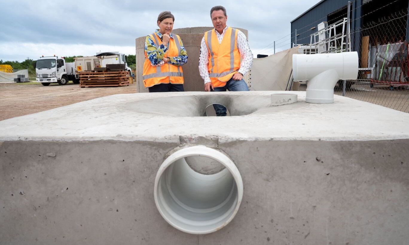 Townsville Mayor Nick Dametto and Member for Mundingburra Janelle Poole inspecting a maintenance hole base
