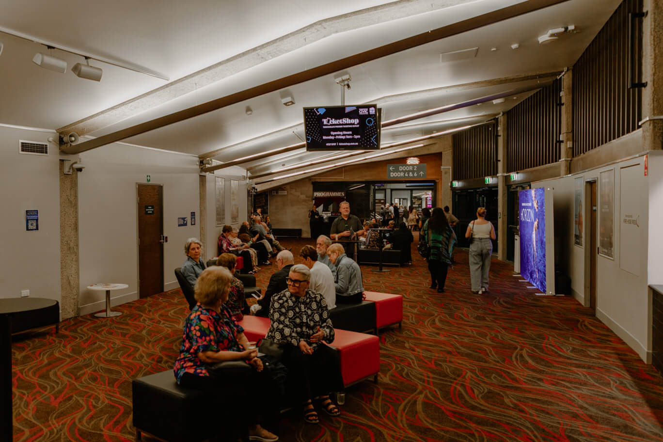 People sitting in the lobby of Townsville Civic Theatre