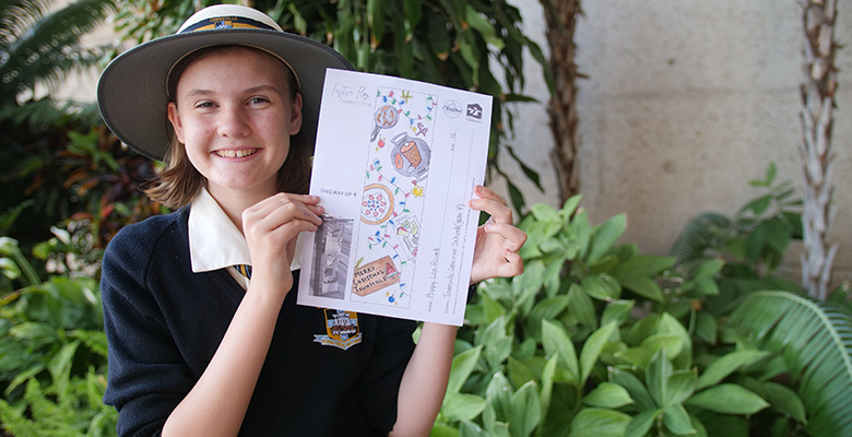Festive Flag Competition winner Poppy Lea-Rowell with her winning design Festive Flag Competition winner Poppy Lea-Rowell with her winning design