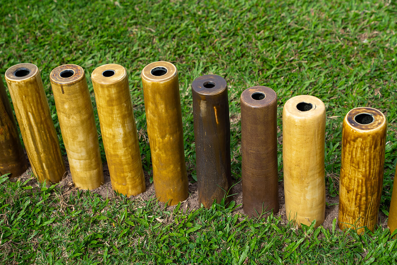 Ceramic vases of various heights in the grass