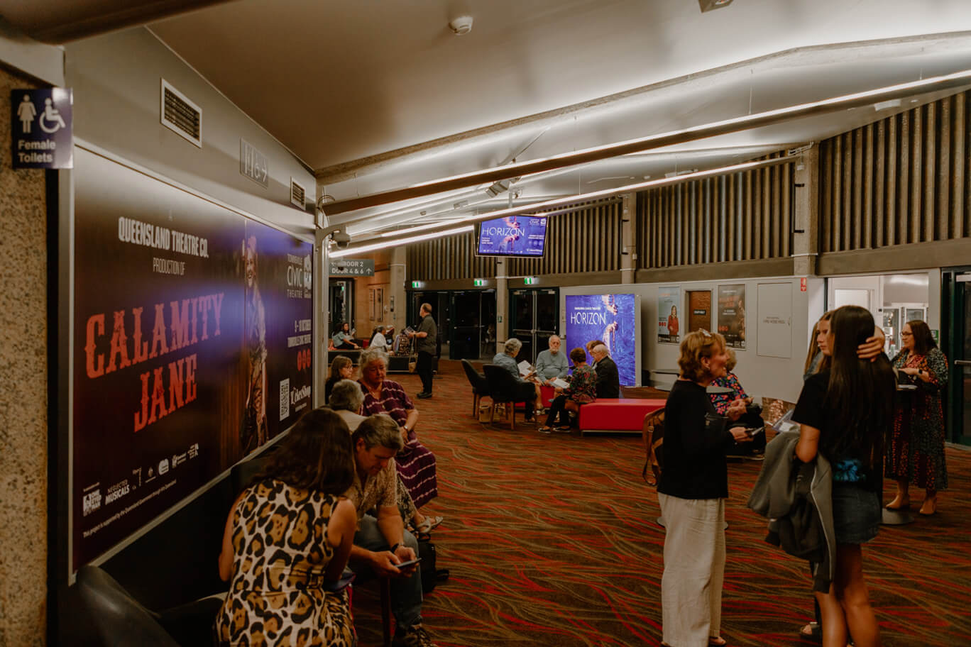 People sitting in the lobby of Townsville Civic Theatre