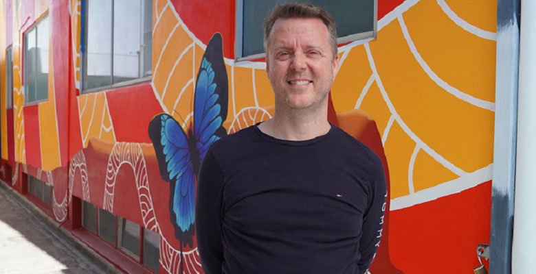 Chris Christensen, pictured in front of Nicky Bidju Pryor’s Coolumbria, is breathing new life into 16 Stokes St thanks to a Council grant. 