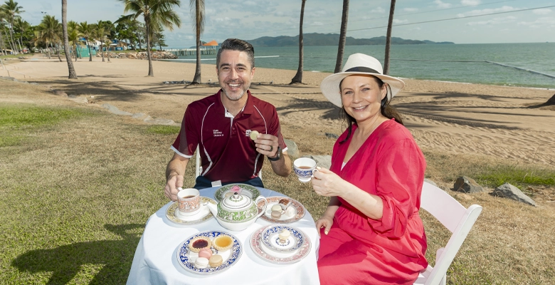 description shown on hover. Councillor Liam Mooney and Townsville City Galleries director Holly Arden enjoy a cup of tea on The Strand.