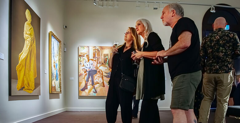 The Percivals 2024 launch event. Image courtesy of Townsville City Galleries. Photo: Through the Looking Glass Studio. People looking at artwork at The Percivals 2024 launch event