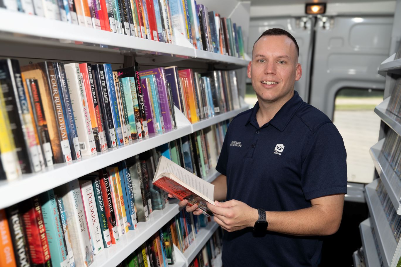 Division 2 Councillor Brodie Phillips checking out the books on offer at the Mobile Library Van.
