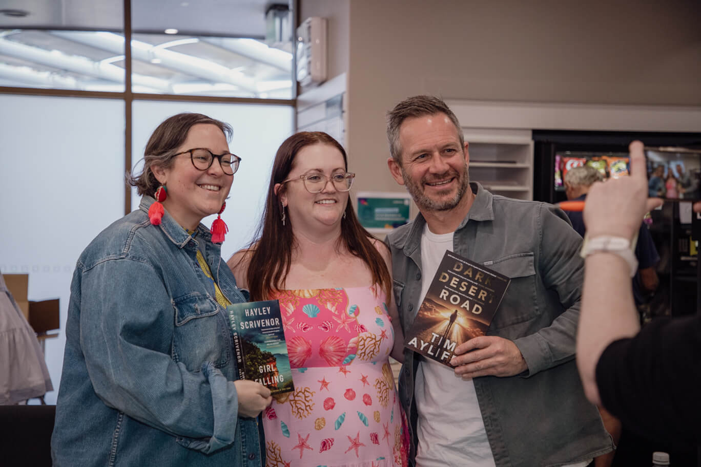 Fan posing with authors Hayley Scrivenor and Tim Ayliffe at Festival of Stories 2026