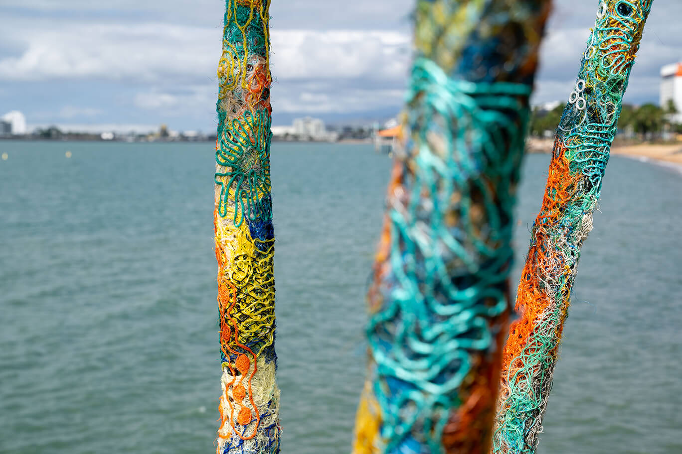 Anemones made of ghost net, beach found rope, sand, fabric, and fishing rod supports