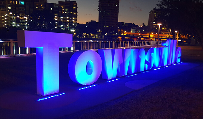 Townsville sign lit up in blue