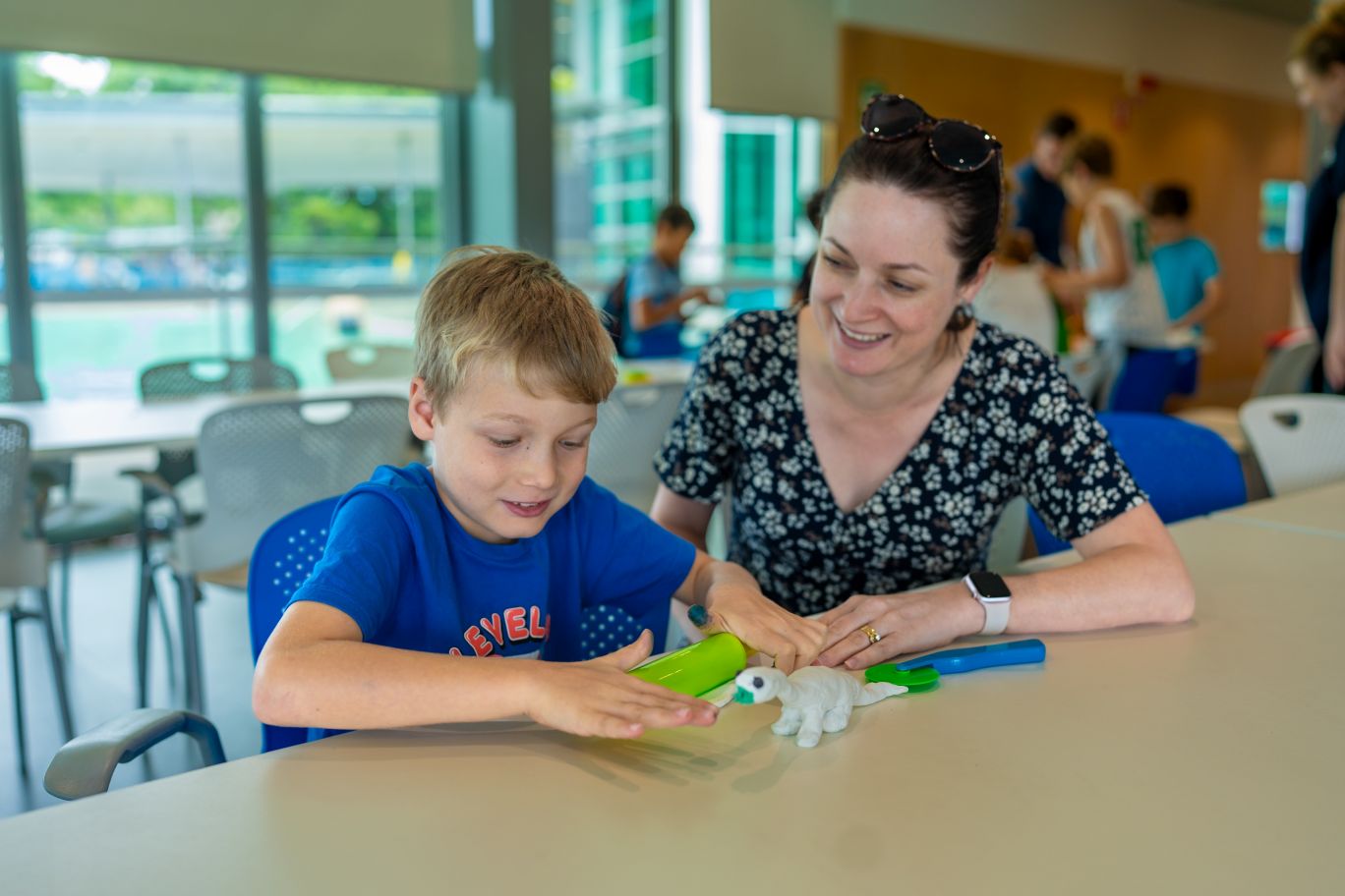 Anthony Smith, 7, with his mum Glenys, having a great time at CityLibraries Riverway's free Dino Model Making sessions this week