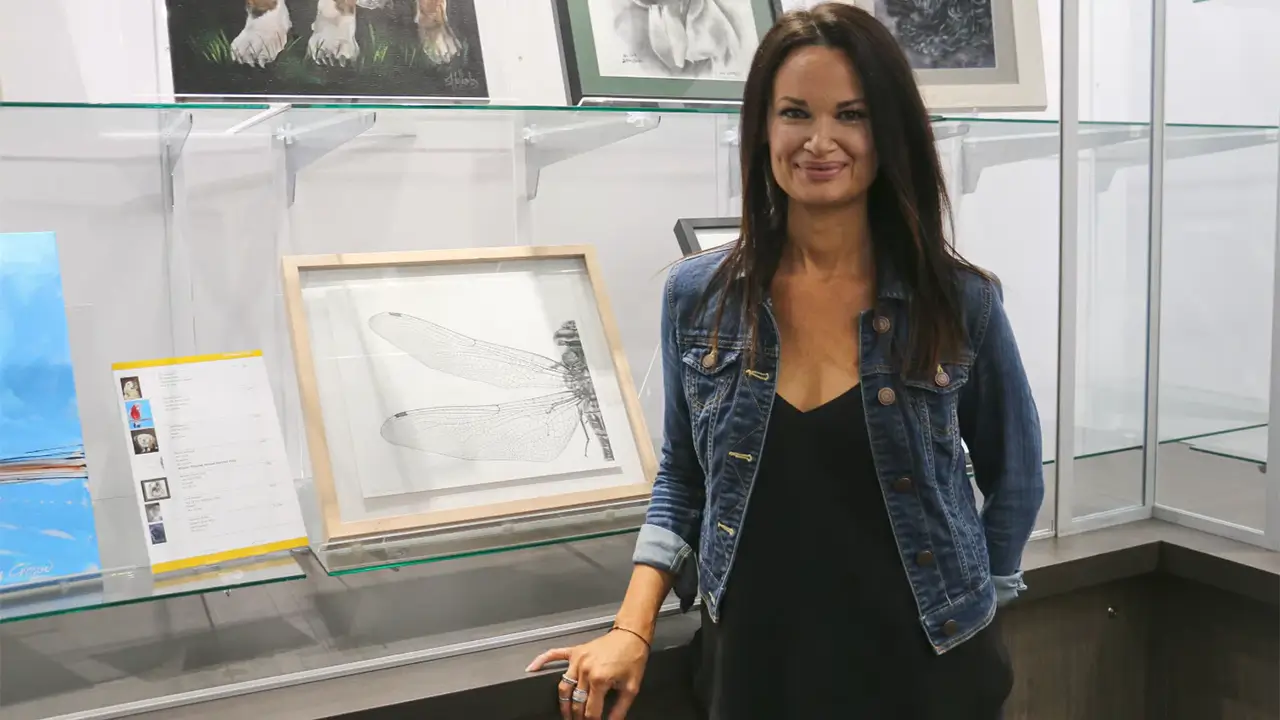 Elissa Sampson standing with her winning artwork