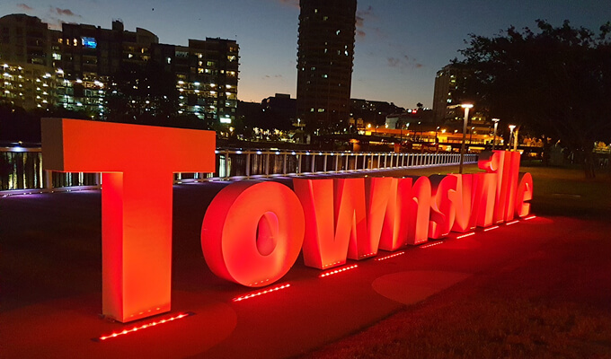 Townsville sign lit up in red