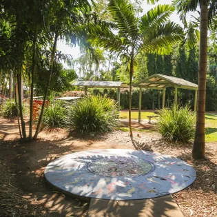 A round mosaic on the ground in the playground area